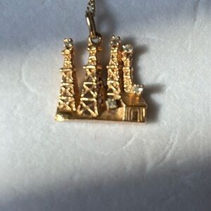 Oilfield wives!  Here is your bling!  14kt gold
Oil rig pendant only.